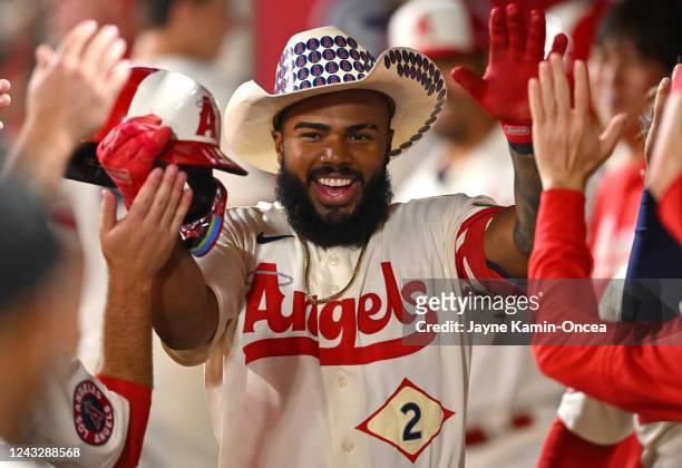 Luis Rengifo of the Los Angeles Angels gets high fives in the dugout after hitting a solo home run in the third inning against the Seattle Mariners...