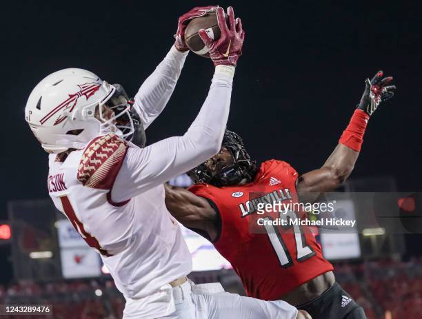 Johnny Wilson of the Florida State Seminoles makes the game winning touchdown catch against Devaughn Mortimer of the Louisville Cardinals during the...