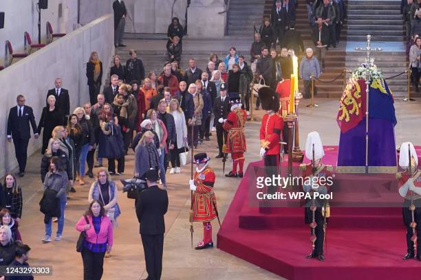 Foreign Secretary James Cleverly with members of the public as they file past the coffin of Queen Elizabeth II, draped in the Royal Standard with the...