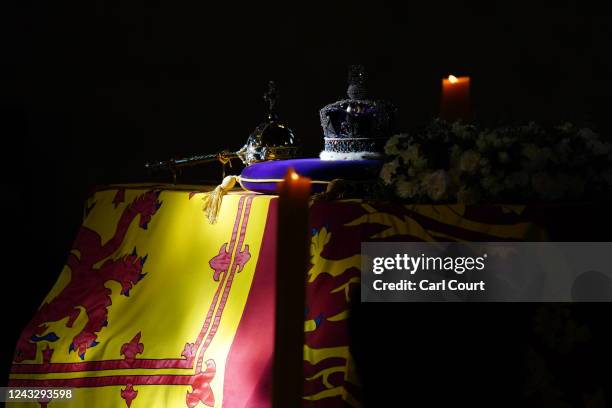 The coffin of Queen Elizabeth II, draped in the Royal Standard with the Imperial State Crown and the Sovereign's orb and sceptre, lies in state on...