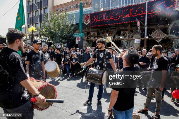 Shiite Muslim devotees bang drums as they gather in Iran's capital Tehran on September 17, 2022 to mark the holy day of Arbaeen , the end of the...