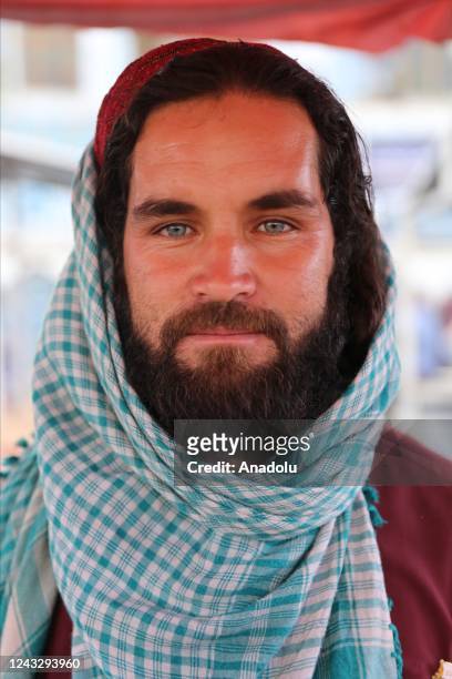 An Afghan man poses for a photo at Mendevi market as daily life continues in Kabul, Afghanistan on September 16, 2022.
