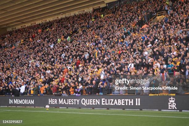 The electronic advertising boards are changed in memory of HM Queen Elizabeth II during the Premier League match between Wolverhampton Wanderers and...