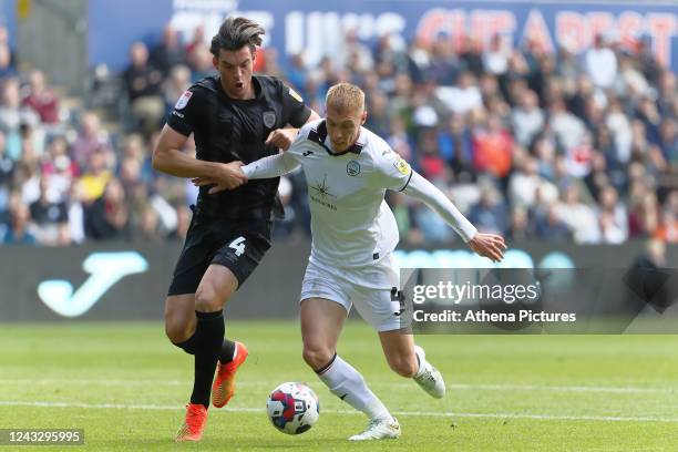 Jacob Greaves of Hull City challenges Jay Fulton of Swansea City during the Sky Bet Championship match between Swansea City and Hull City at the...