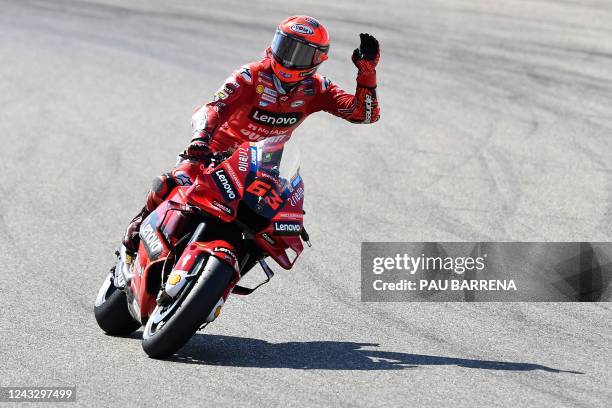 Ducati Italian rider Francesco Bagnaia celebrates getting the pole position after finishing the qualifying session in first place on the eve of the...