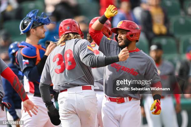 Edison Valerio of Team Spain high-fives Chris Kwitzer after hitting a grand slam in the fifth inning during Game 3 between Team Spain and Team Czech...