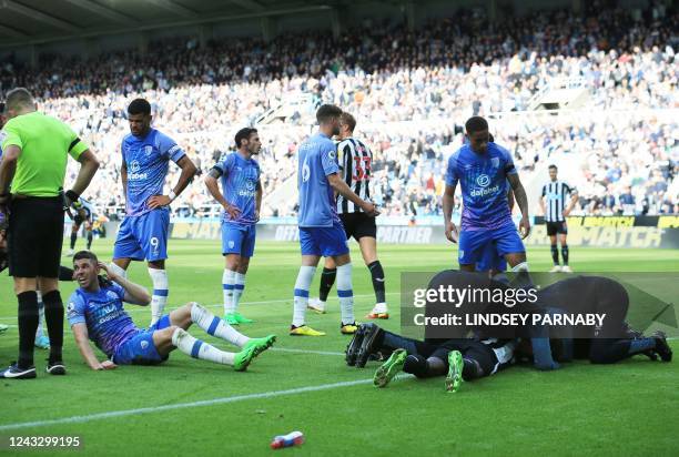 Newcastle United's Swedish striker Alexander Isak and Bournemouth's Scottish midfielder Ryan Christie receives medical treatment during the English...