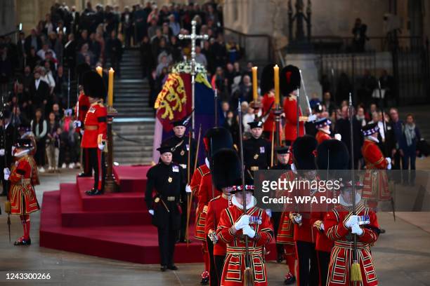 Members of the King's Bodyguard from the Royal Company of Archers, the Yeomen of the Guard and Coldstream Guards leave after guarding the coffin of...