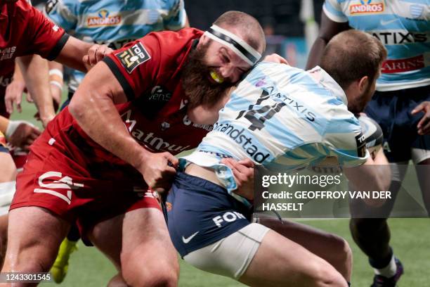 Racing 92's French wing Louis Dupichot is tackled by New Zealand's hooker Liam Coltman during the French Top 14 rugby union match between Racing...