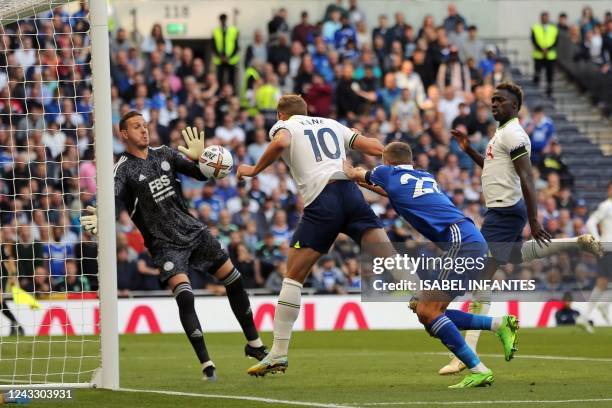 Tottenham Hotspur's English striker Harry Kane heads the ball to score his team's first goal past Leicester City's Welsh goalkeeper Danny Ward during...