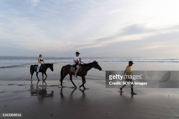 Tourists ride horses during evening hours at Seminyak Beach. Tourism in Indonesia is picking up after the covid 19 pandemic. The government has...