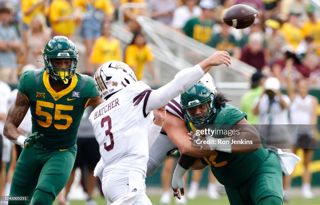 Baylor Riggins Siaki Ika of the Baylor Bears and teammate Garmon Randolph pressure ...
