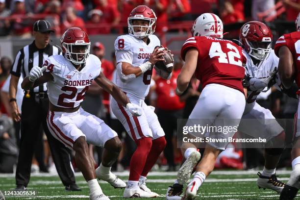 Quarterback Dillon Gabriel of the Oklahoma Sooners looks to pass against linebacker Nick Henrich of the Nebraska Cornhuskers during the first quarter...