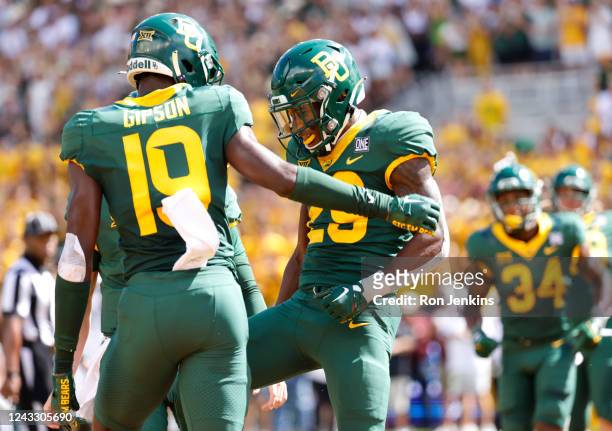 Richard Reese of the Baylor Bears and teammate Javon Gipson celebrate Reeses touchdown against the Texas State Bobcats in the first half at McLane...