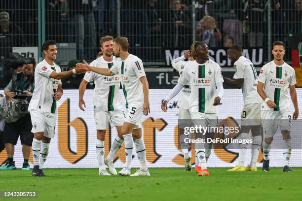Ramy Bensebaini of Borussia Moenchengladbach celebrates after scoring his team's third goal with teammates during the Bundesliga match between...