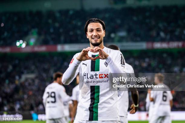 Ramy Bensebaini of Borussia Moenchengladbach celebrates after he scored his team's third goal during the Bundesliga match between Borussia...