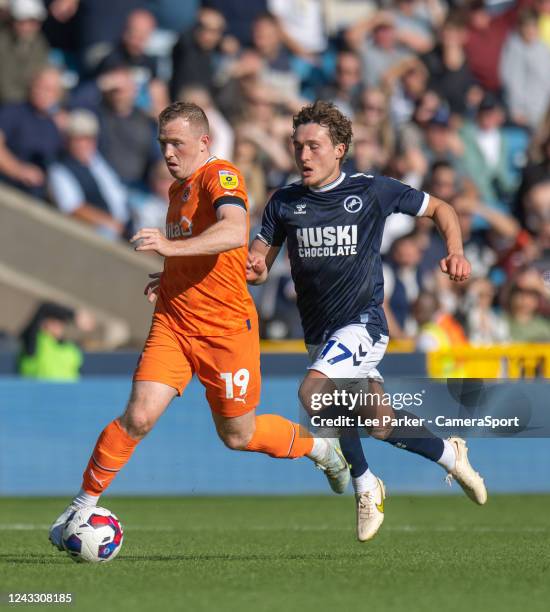 Blackpool's Shayne Lavery under pressure from Millwall's Callum Styles during the Sky Bet Championship between Millwall and Blackpool at The Den on...