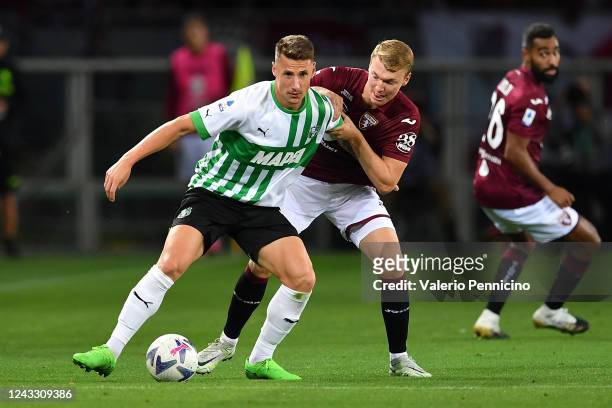 Perr Schuurs of Torino FC competes with Andrea Pinamonti of US Sassuolo during the Serie A match between Torino FC and US Sassuolo at Stadio Olimpico...