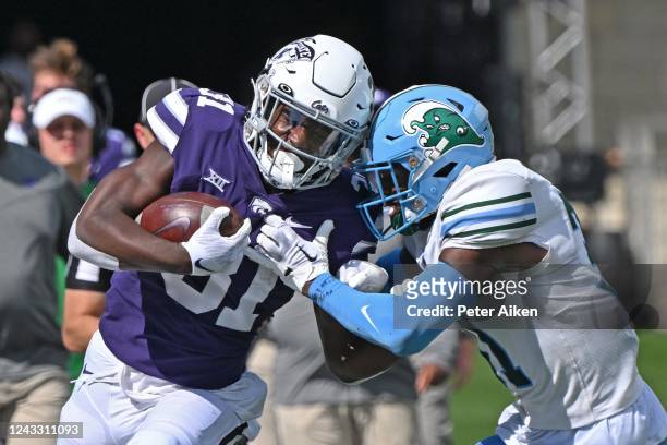 Running back DJ Giddens of the Kansas State Wildcats runs up field against safety Larry Brooks of the Tulane Green Wave during the first half at Bill...