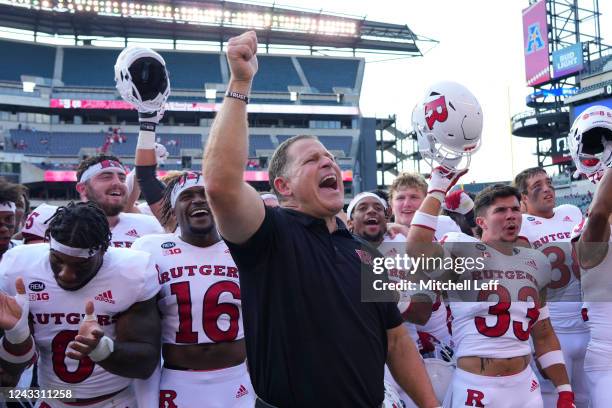 Head coach Greg Schiano of the Rutgers Scarlet Knights celebrates along with his team after the game against the Temple Owls at Lincoln Financial...