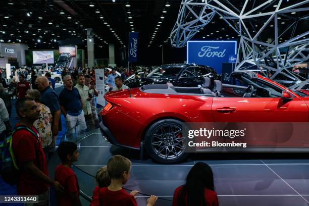 Attendees view a Ford Mustang GT vehicle during the 2022 North American International Auto Show in Detroit, Michigan, US, on Saturday, Sept. 17,...