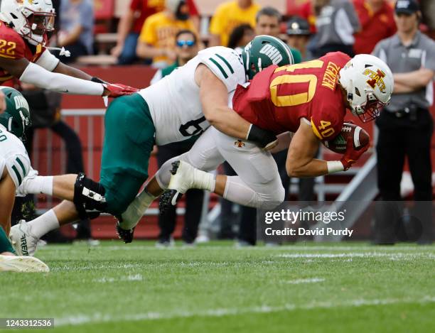 Linebacker Hunter Zenzen of the Iowa State Cyclones recover a fumble as offensive lineman Christophe Atkinson of the Ohio Bobcats defends in the...