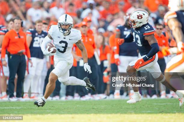 Wide receiver Parker Washington of the Penn State Nittany Lions runs the ball by linebacker Cam Riley of the Auburn Tigers during the second half of...