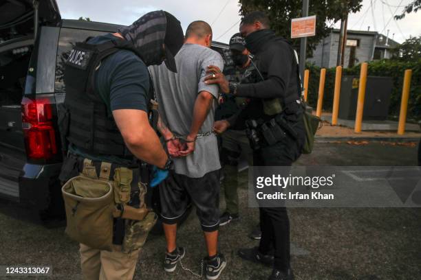 Los Angeles, CA Immigration and Customs Enforcement agents apprehend an an illegal immigrant with criminal record, in an early morning raid at home...