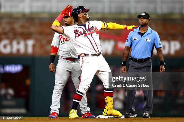 Ronald Acuna Jr. #13 of the Atlanta Braves celebrates after hitting a two-RBI double in the bottom of the fourth inning against the Philadelphia...