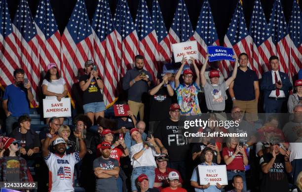 Audience members listen to former President Donald Trump speak inside the Covelli Centre at a Save America Rally to support Republican candidates...