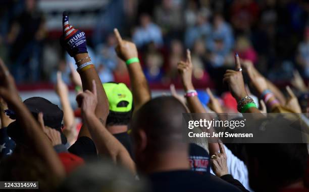 Audience members put their index finger up to symbolize America First while President Donald Trump speaks at a Save America Rally to support...