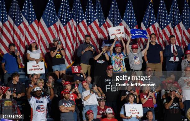 Audience members listen to former President Donald Trump speak at a Save America Rally to support Republican candidates running for state and federal...