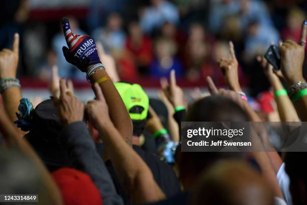 Audience members put their index finger up to symbolize America First while President Donald Trump speaks at a Save America Rally to support...