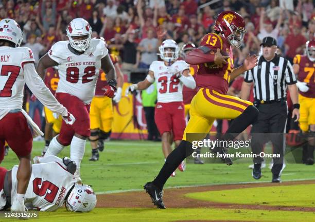 Quarterback Caleb Williams of the USC Trojans breaks away from defensive end Da'Marcus Johnson of the Fresno State Bulldogs and runs into the end...