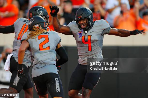 Linebacker Nickolas Martin celebrates a touchdown by teammate Korie Black of the Oklahoma State Cowboys after a blocked field goal attempt against...