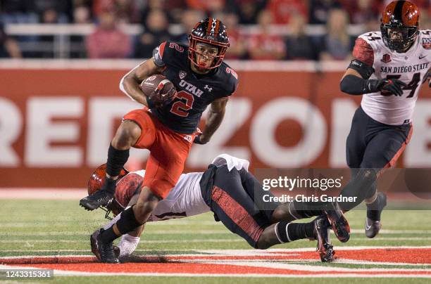 Micah Bernard of the Utah Utes breaks a tackle attempt by Davaughn Celestine of the San Diego State Aztecs during the first half of their game...
