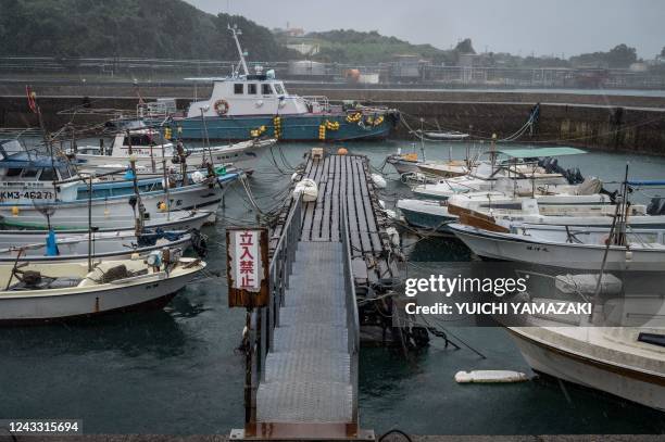 Fishing boats are seen moored as rain falls from weather patterns brought about by Typhoon Nanmadol at a port in Minamata, Kumamoto prefecture on...