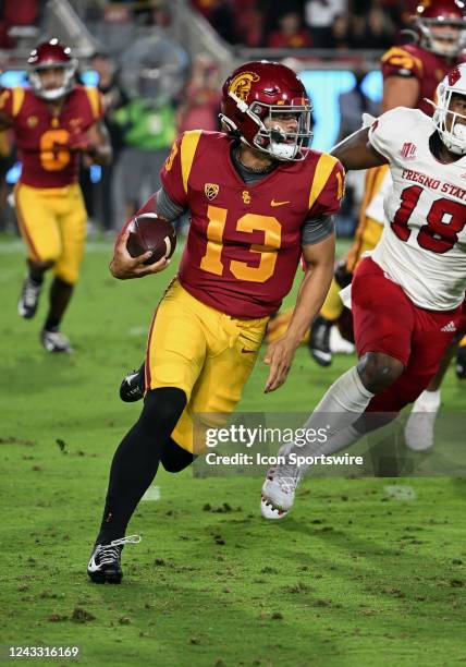 Trojans quarterback Caleb Williams gains yards running with the ball in the first half of an NCAA football game against the Fresno State Bulldogs...