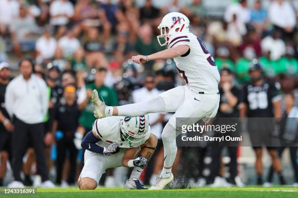 Brian Bruzdewicz of the Duquesne Dukes kicks a filed goal as Trey King holds the ball during the first half of an NCAA football game against the...