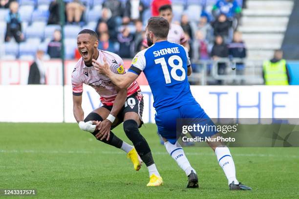 Thomas Ince of Reading FC fouled by Graeme Shinnie of Wigan Athletic during the Sky Bet Championship match between Wigan Athletic and Reading at the...
