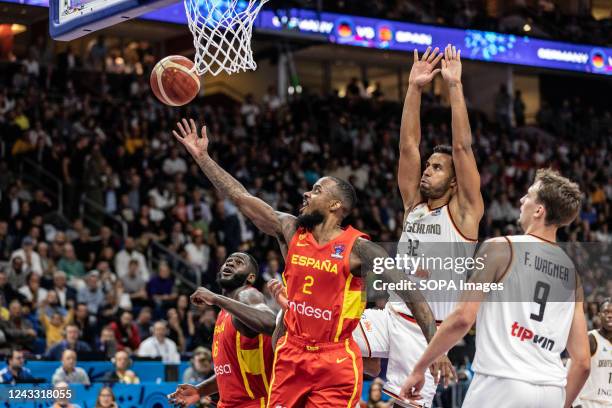 Lorenzo Brown of Spain and Johannes Thiemann and Franz Wagner of Germany seen in action during the semifinal of the FIBA Eurobasket 2022 between...