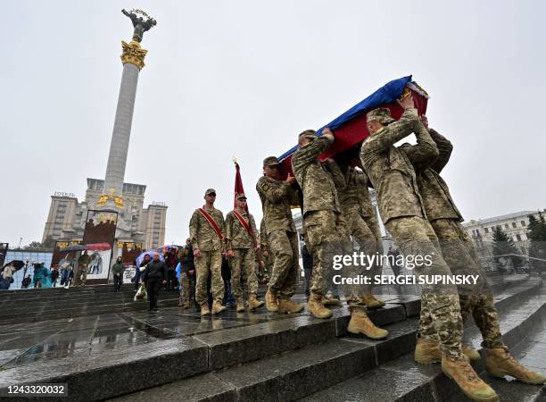 Ukrainian soldiers carry a coffin with the body of Roman Kosenko, nicknamed Yashka, and an active participant in the 2014 Maidan revolution, who died...