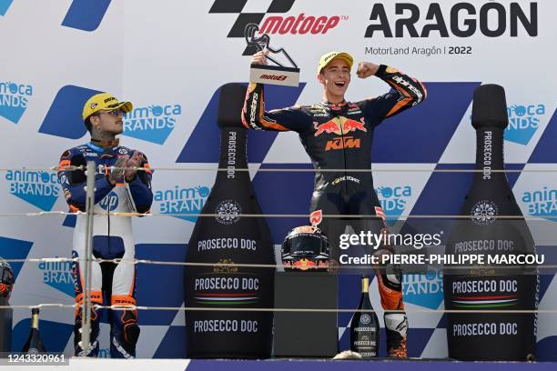 First placed Red Bull KTM Ajo's Spanish rider Pedro Acosta , celebrates next to third placed Speed Up Inde AsparTeam Moto2's Spanish rider Aron Canet...