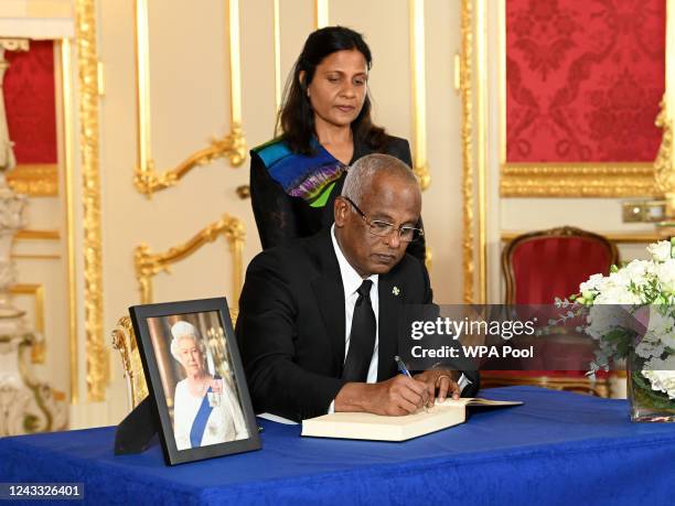 President of the Maldives Ibrahim Mohamed Solih and First Lady Fazna Ahmed sign a book of condolence at Lancaster House on September 18, 2022 in...