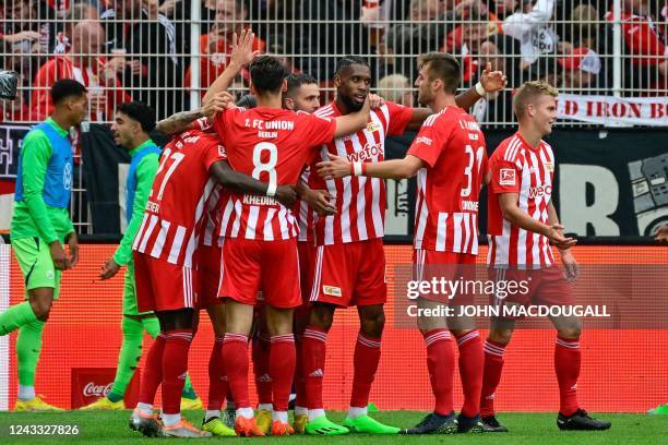 Union Berlin's French forward Jordan Siebatcheu celebrates scoring the opening goal with his teammates during the German first division Bundesliga...