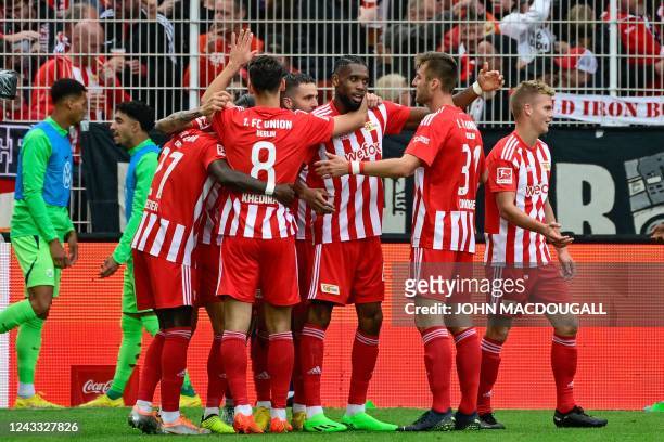 Union Berlin's French forward Jordan Siebatcheu celebrates scoring the opening goal with his teammates during the German first division Bundesliga...