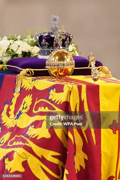 The coffin of Queen Elizabeth II, draped in the Royal Standard with the Imperial State Crown and the Sovereign's orb and sceptre, lies in state on...