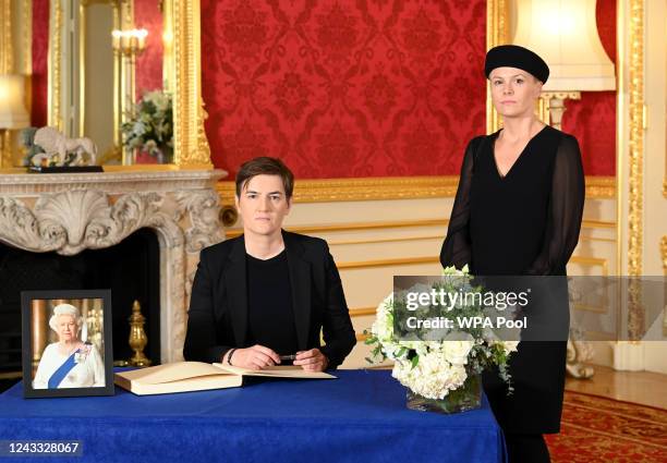 Serbian Prime Minister Ana Brnabic with her partner Milica Durdic signs a book of condolence at Lancaster House on September 18, 2022 in London,...