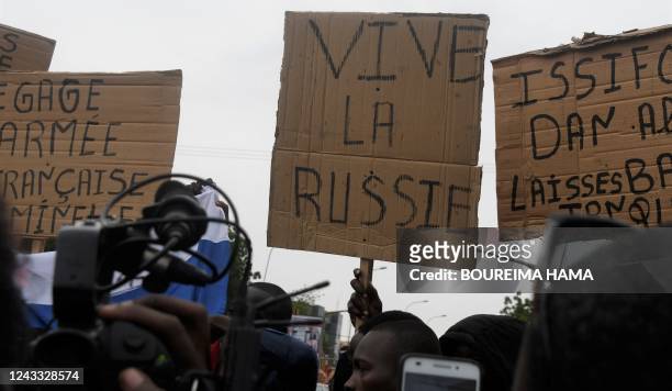Man holds a placard reading "Long live Russia" as people demonstrate against French military presence in Niger on September 18, 2022 in Niamey....