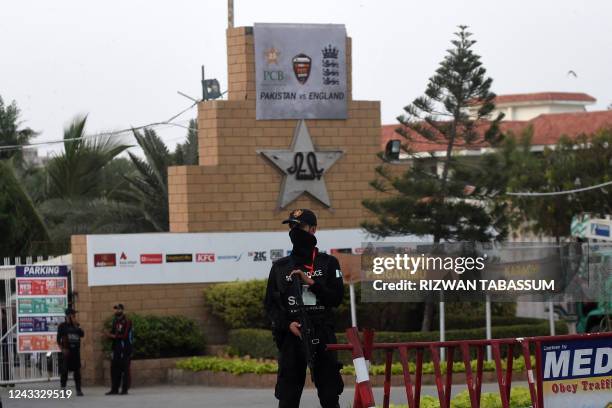 Members of security personnel stand guard during the arrival of England's and Pakistani cricketers and their team officials for a training session...